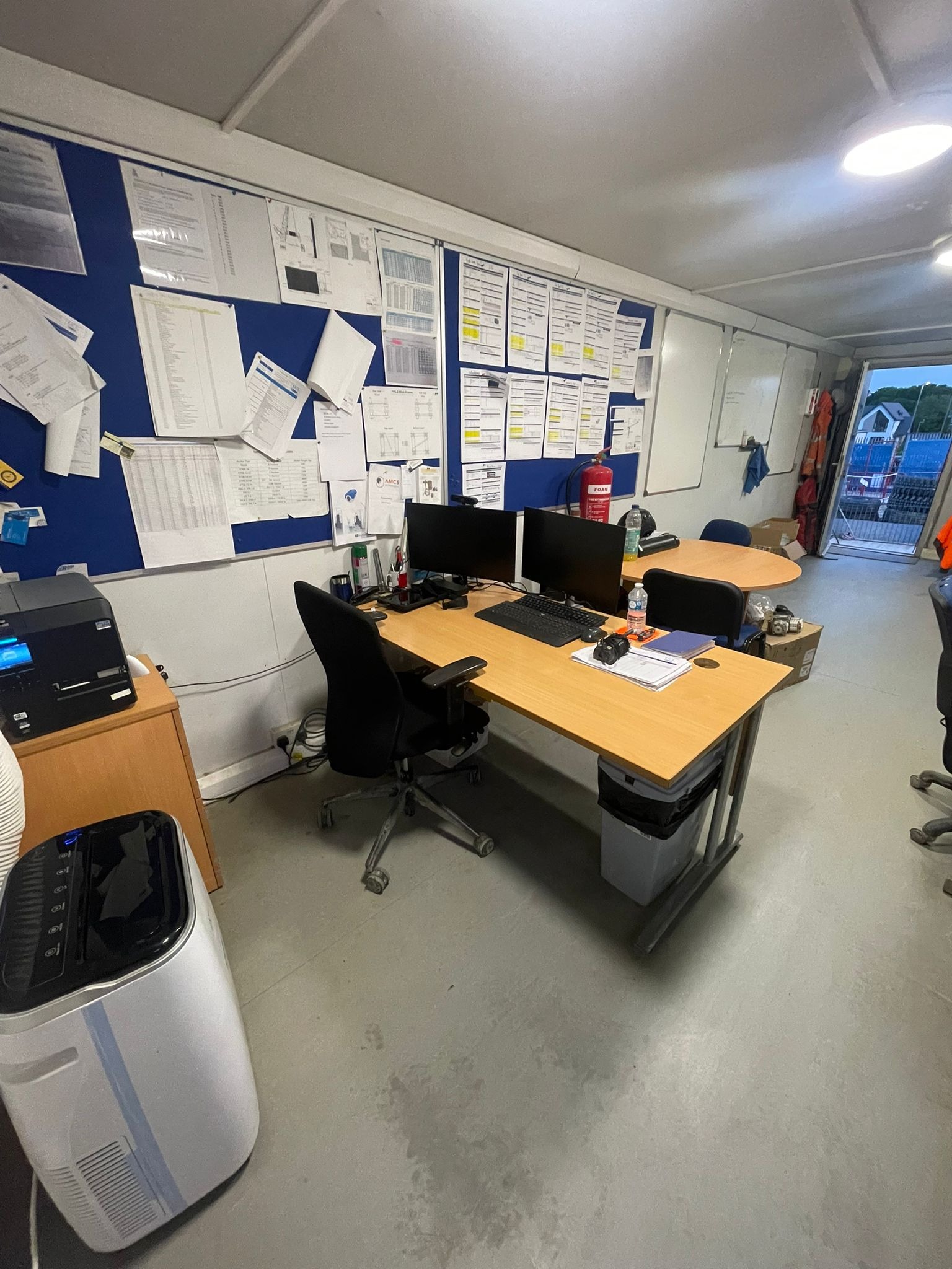 Site office workstations cleaned and organised as part of a commercial cleaning contract