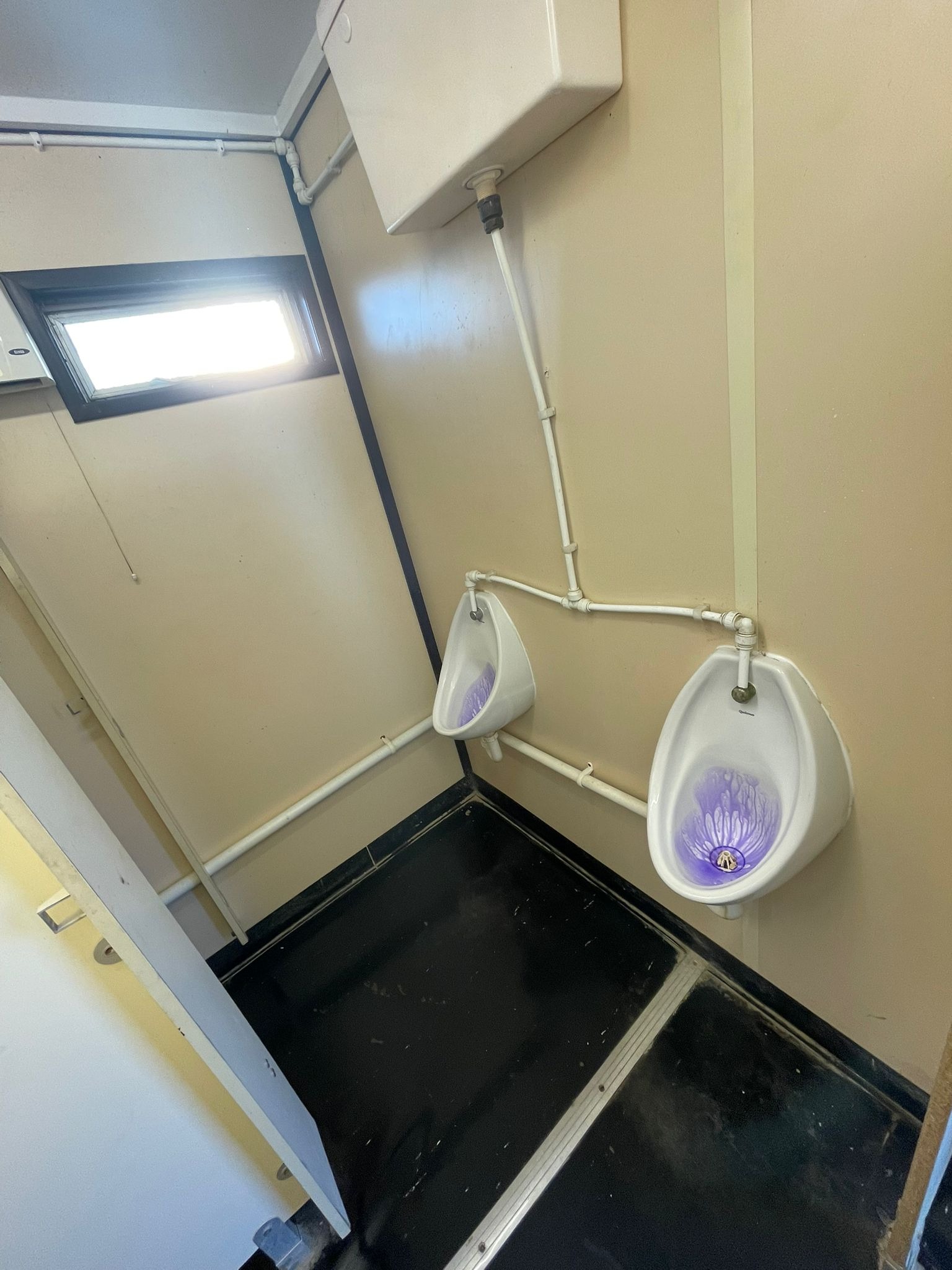 Portable site welfare unit toilet cubicle, cleaned and sanitised on a commercial contract